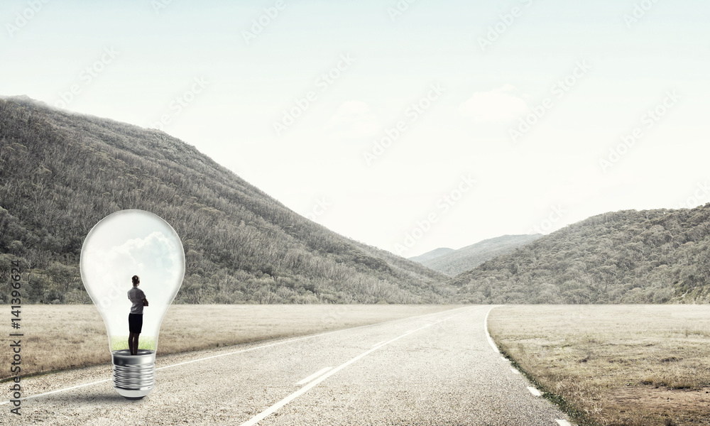 Businesswoman inside light bulb