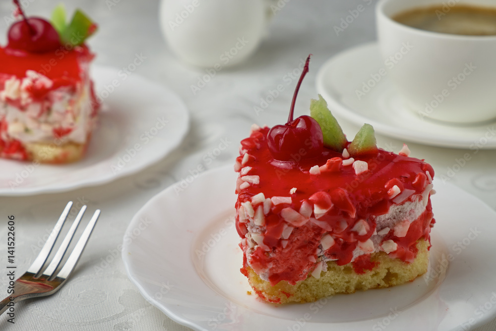 Delicious dessert cake with cream and cherry