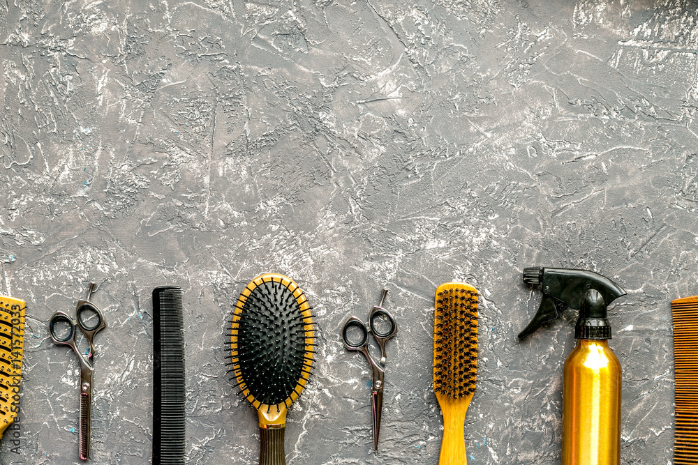 Tools for hairdress in barbershop on gray background top view mock up