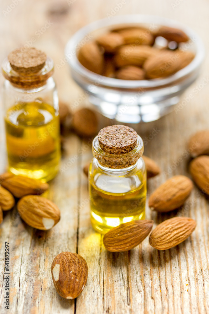 cosmetic and therapeutic almond oil on wooden background