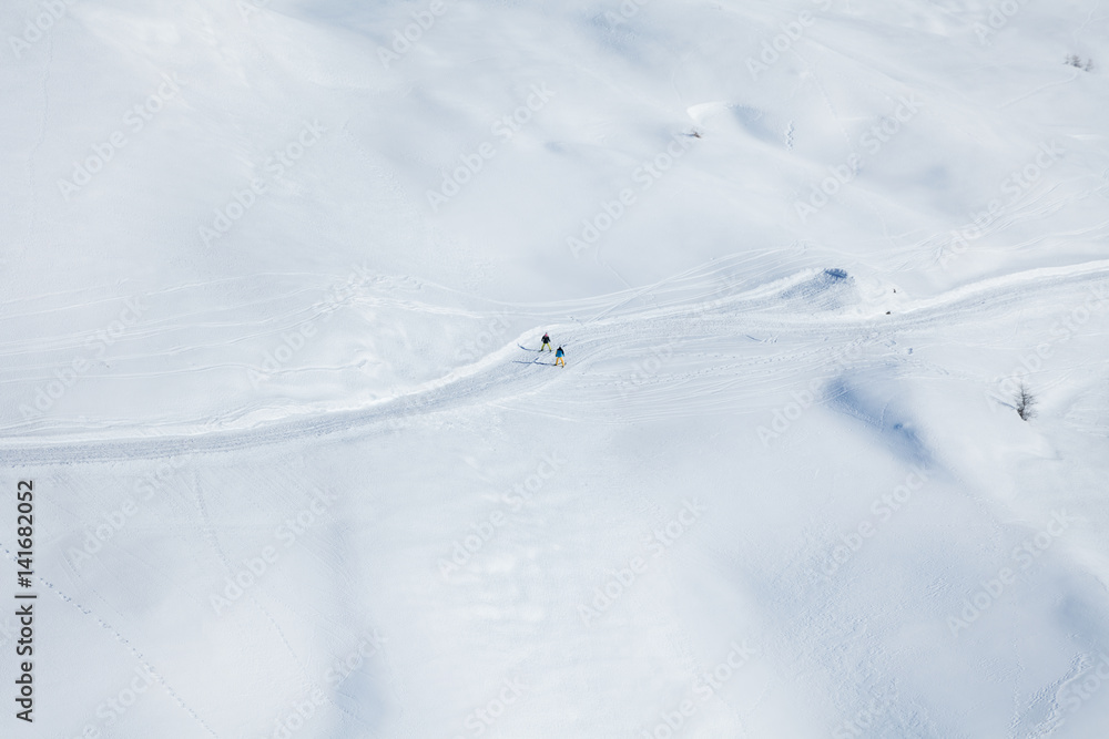 Two skiers running on the snowcapped mountains