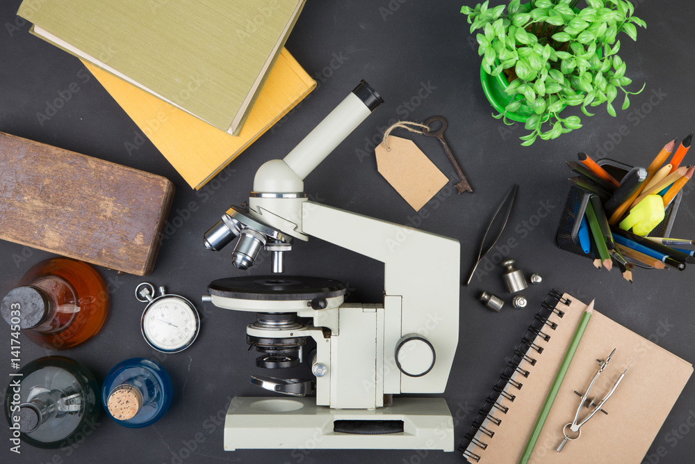 Education concept books and microscope on the desk in the auditorium