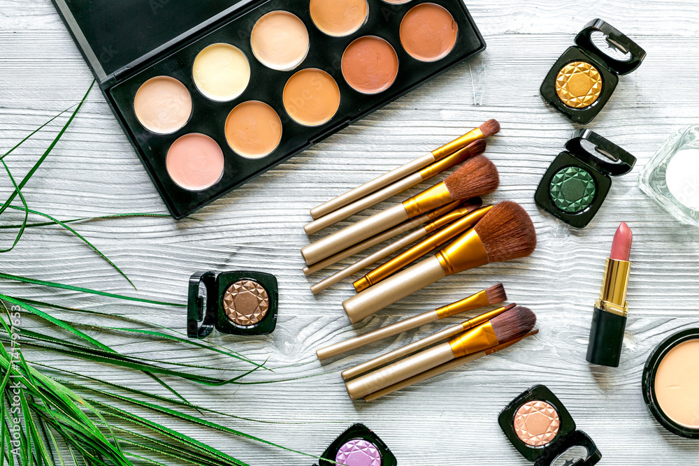 cosmetic set with eye shadow on woman table background top view