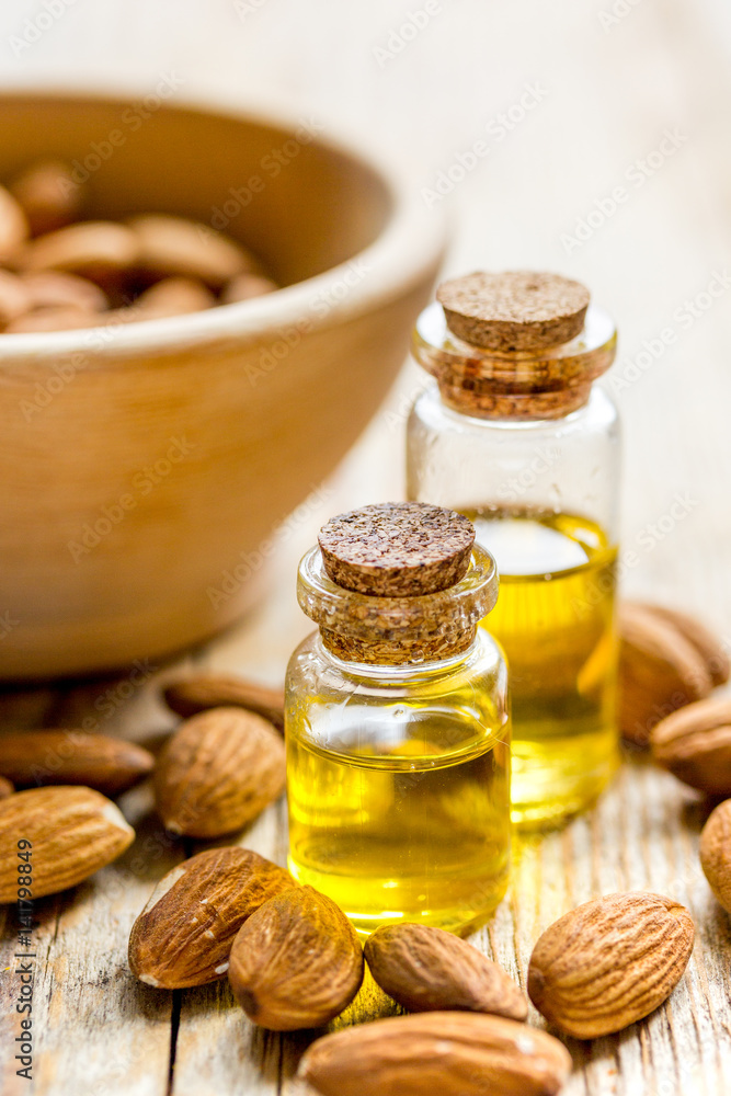 cosmetic set with almond oil on wooden table background