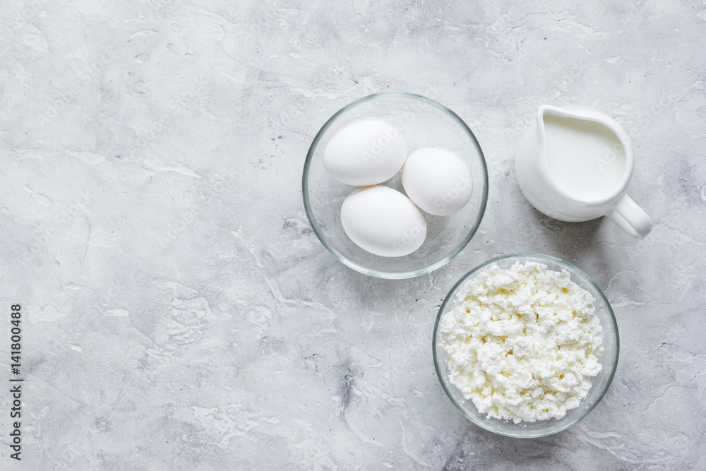 Fresh dairy products on stone table background top view mock up