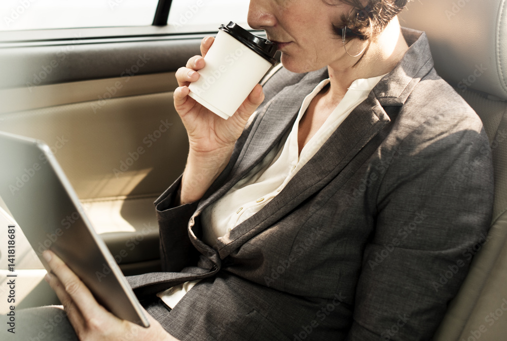 Businesswoman Using Tablet Car Inside