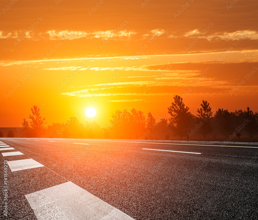 Asphalt road and sky at sunset