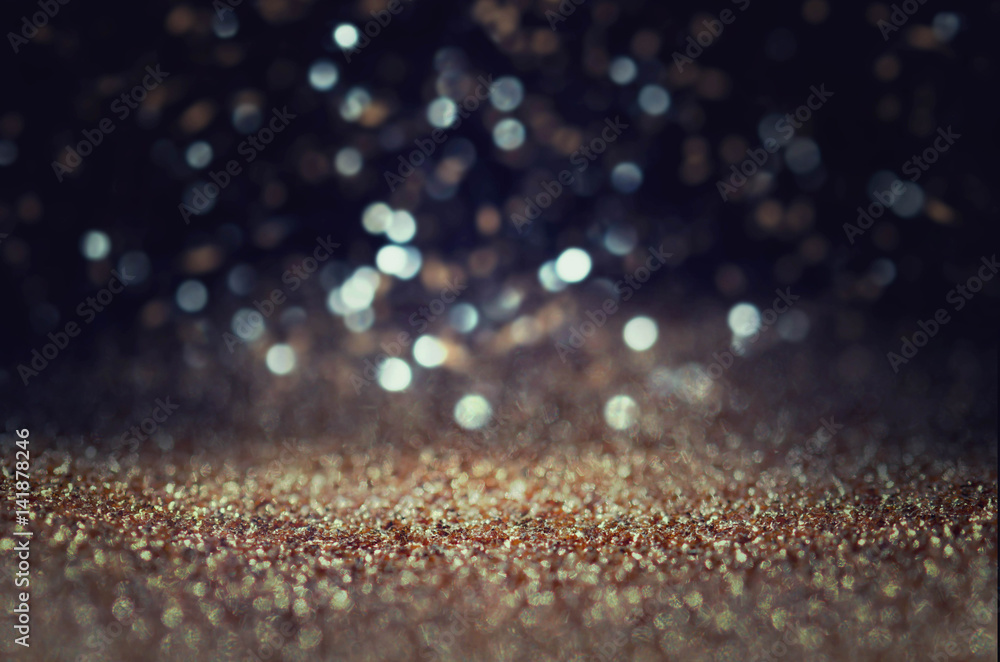 glitter light background. gold, silver, blue and black. de-focused.