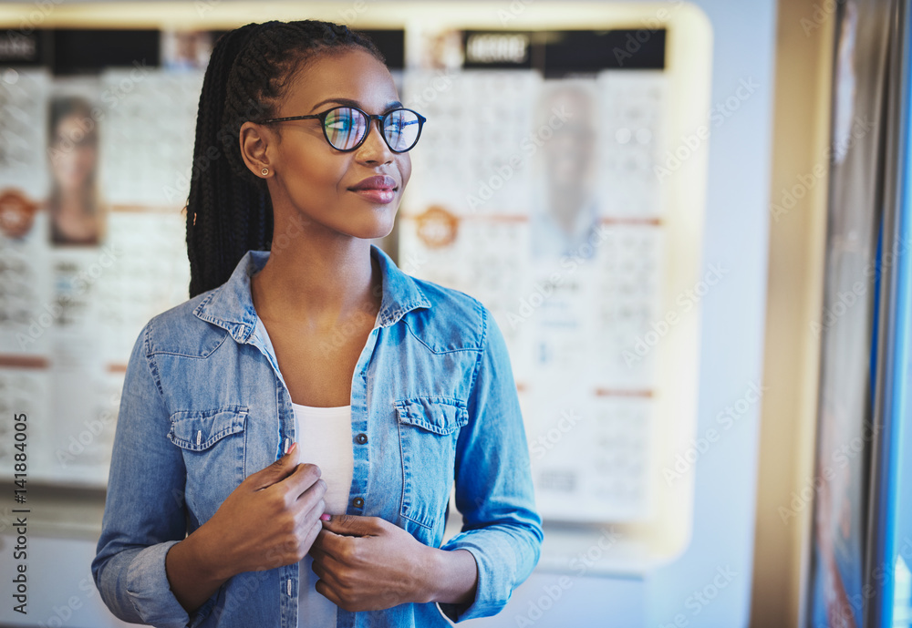 Satisfied young woman wearing eyeglasses at store