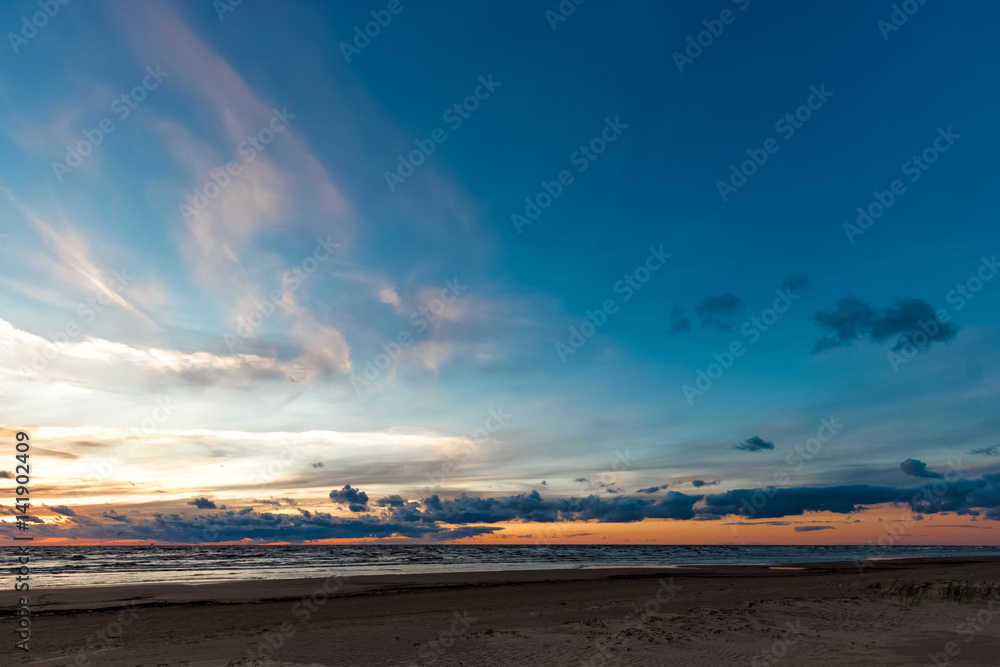 Blue cloudy sky over the Baltic sea at evening