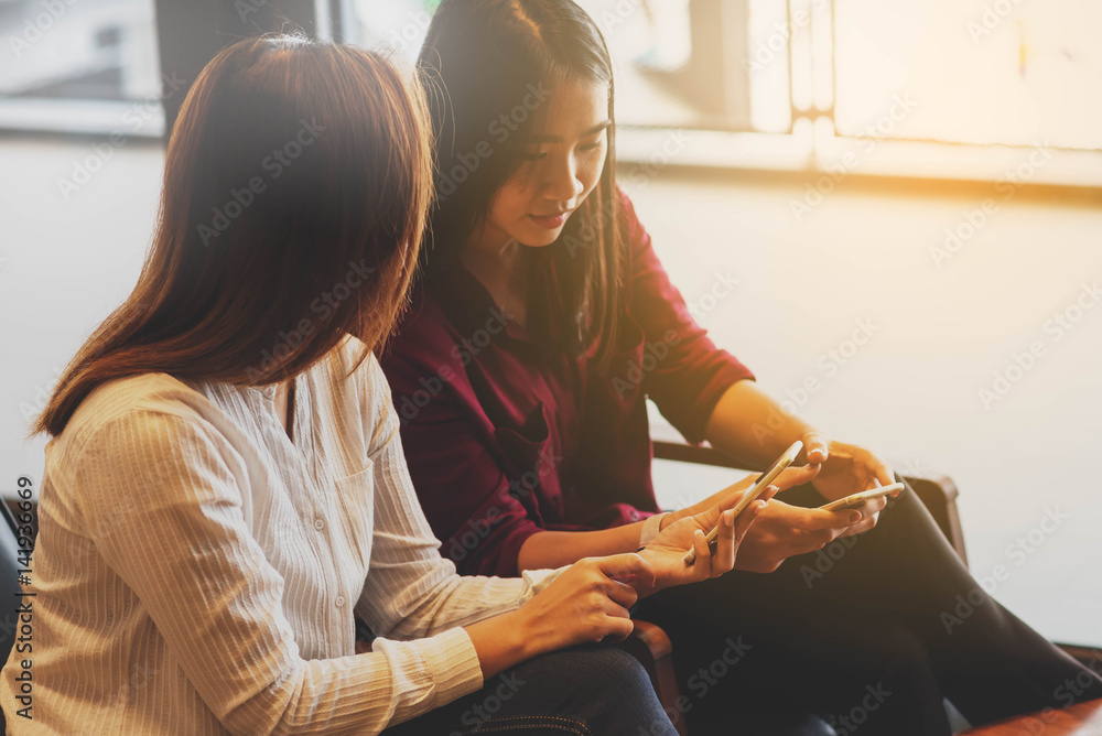 Two woman using smartphone sharing data, iot, internet of things conceptual