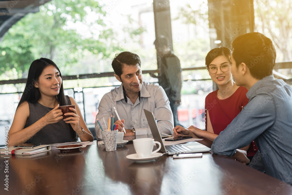 4 people meeting in coffee shop, business casual conceptual