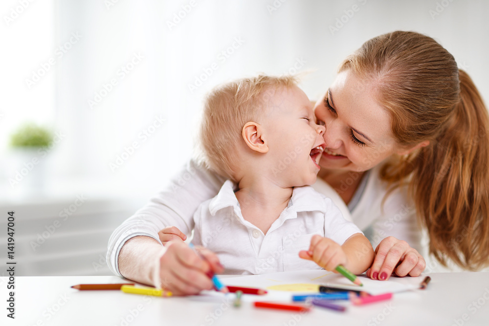 Mother with baby son with colored pencils