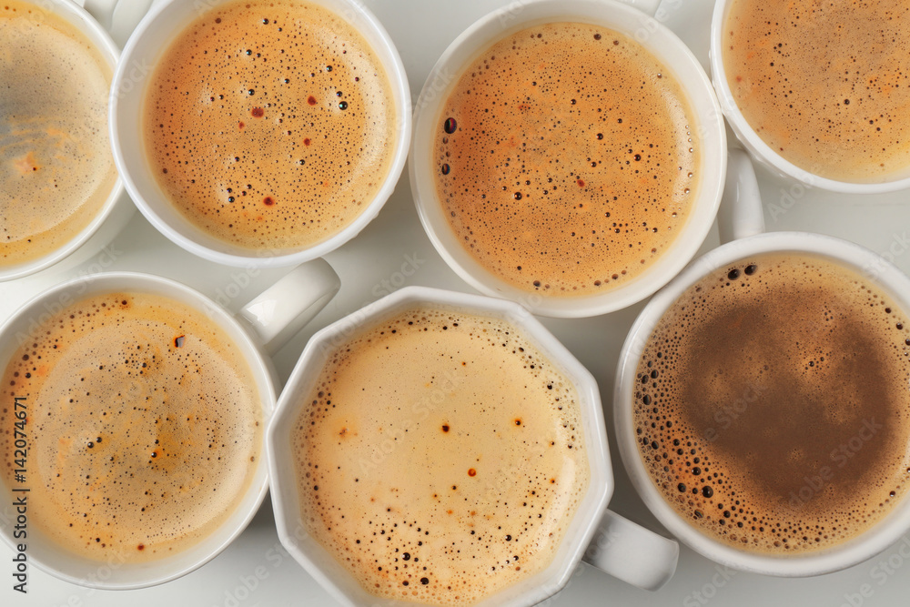 Cups of coffee on white background