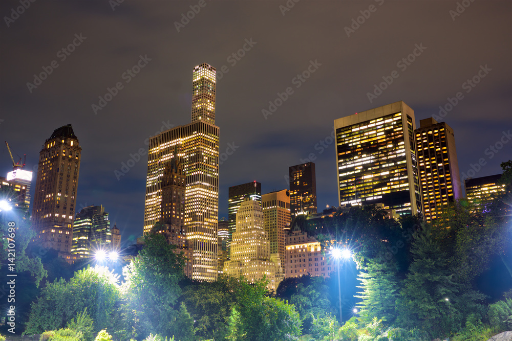 Urban skyscrapers from Central Park at night in New York