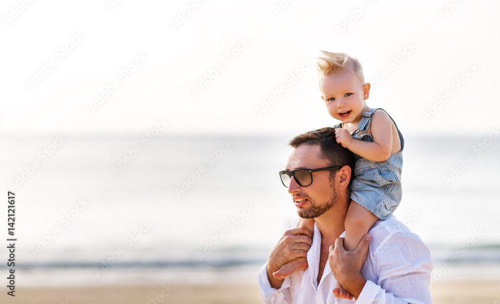 fathers day. Dad and baby son playing together outdoors on a summer