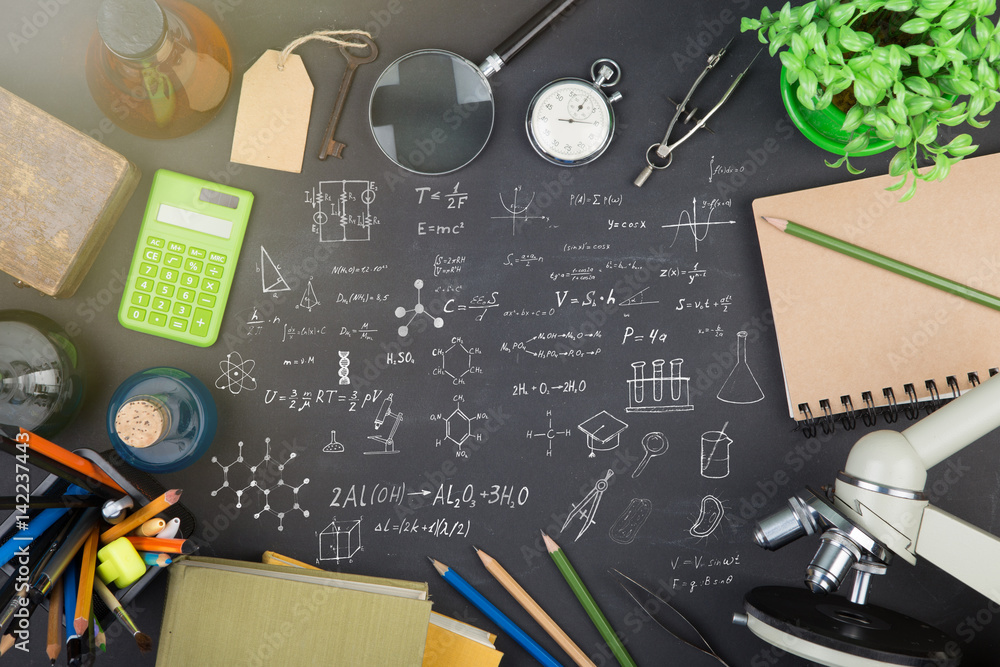 Education concept - books, microscope and Science sketch on the blackboard