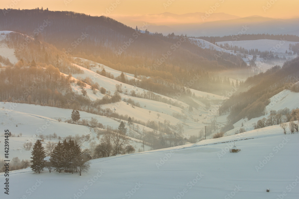 Beautiful winter mountain landscape with snowflakes in frosty winter day. Carpathian wild mountains.