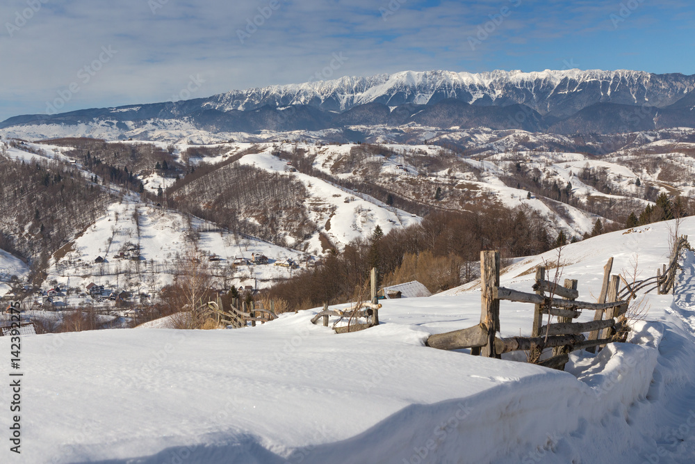 Beautiful winter mountain landscape with snowflakes in frosty winter day. Carpathian wild mountains.