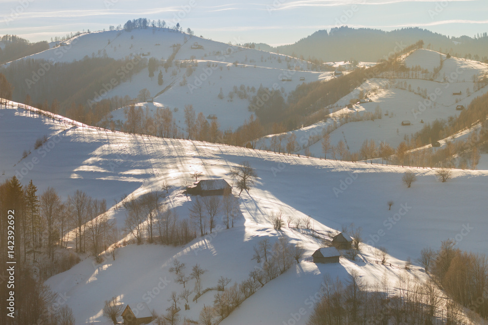 Beautiful winter mountain landscape with snowflakes in frosty winter day. Carpathian wild mountains.