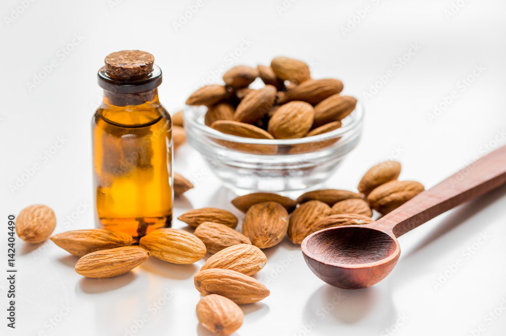 organic cosmetic with almond extract on table background