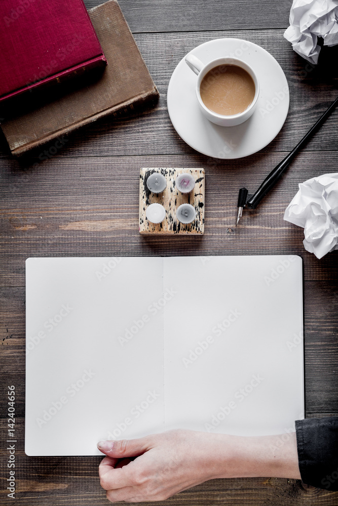 writer workplace with tools on wooden background top view