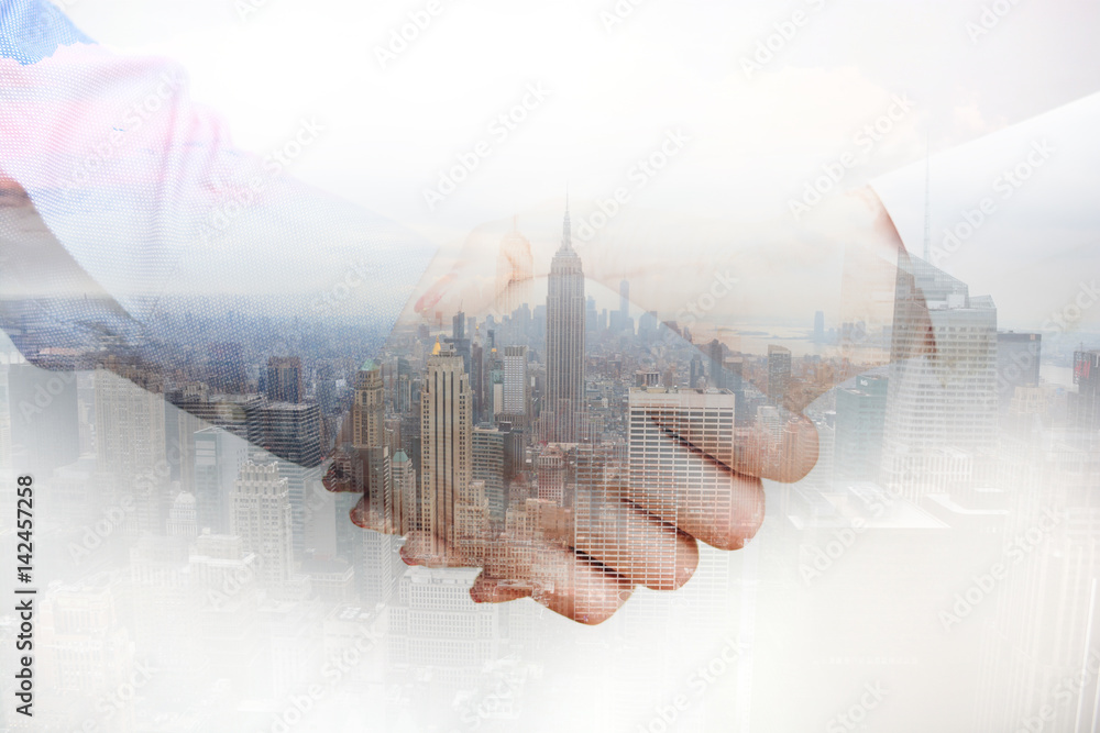 Composite image with business people shaking hands and city skyscrapers