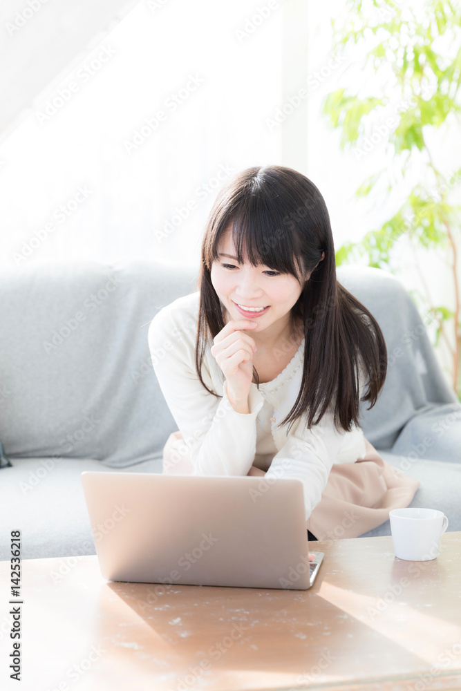 attractive asian woman relaxing in living room