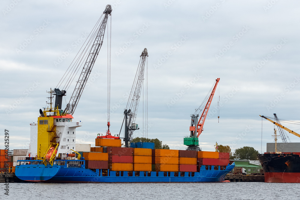 Blue container ship loading in cargo port of Europe