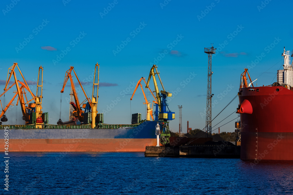 Blue cargo ship loading in the port of Riga, Europe