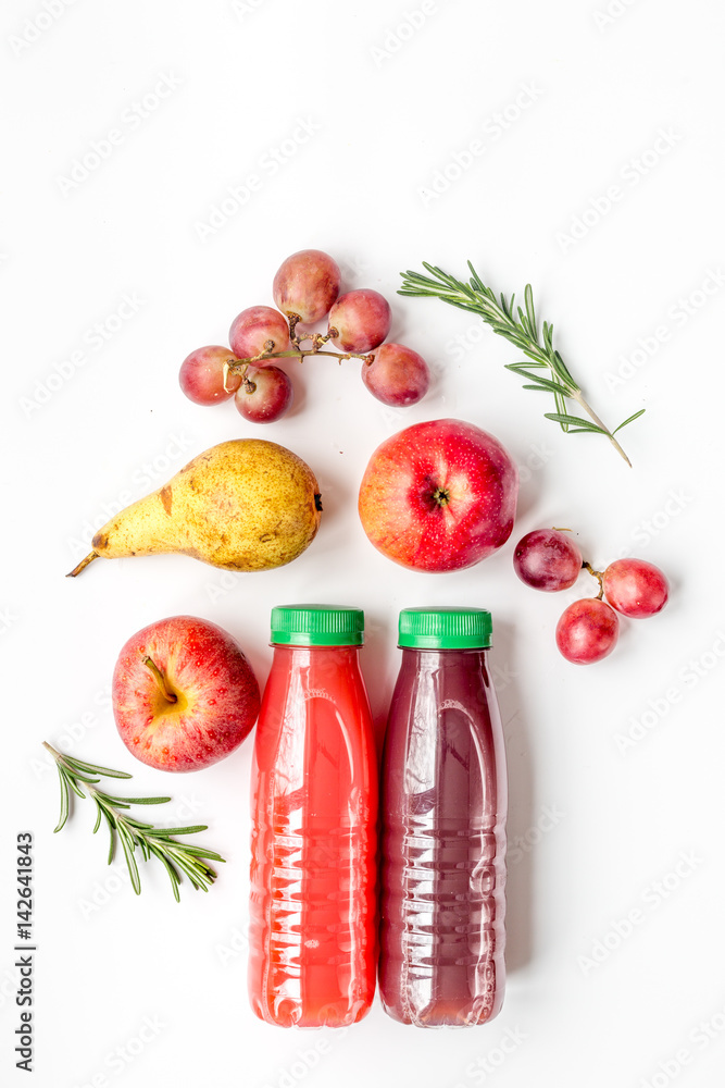 plastic bottles with fruit drinks on white background top view mock up