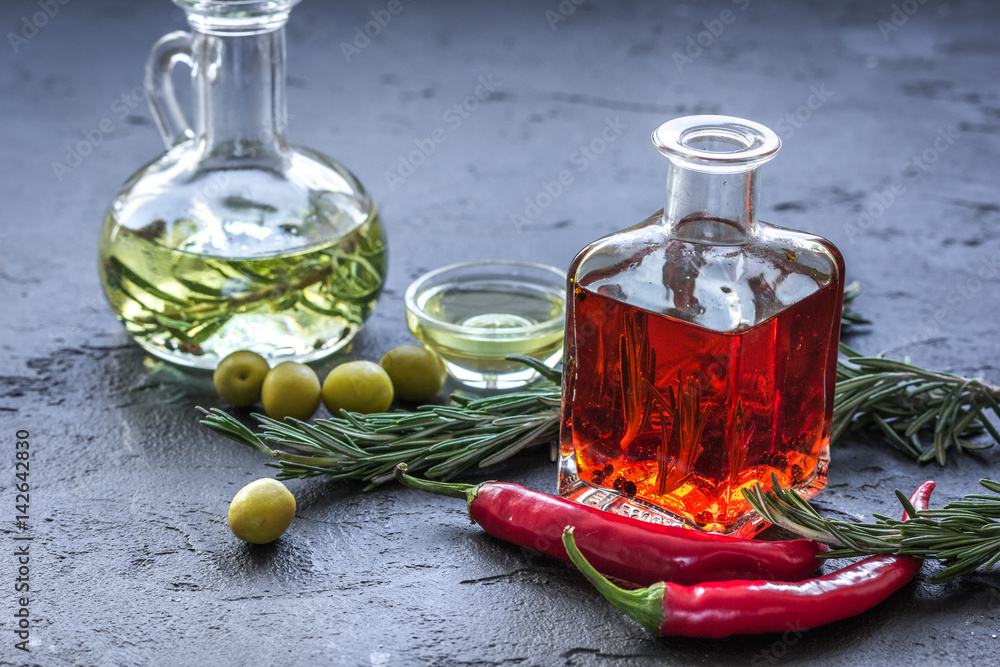 natural oils concept with fresh olives and chili paper on table background