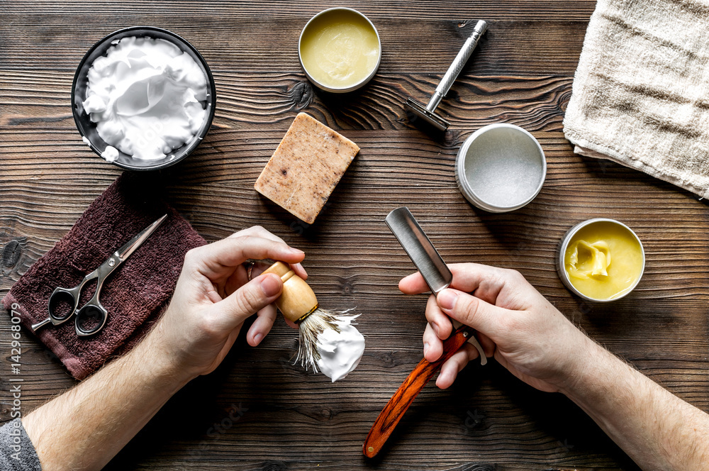 babrer workplace with tools on wooden background top view