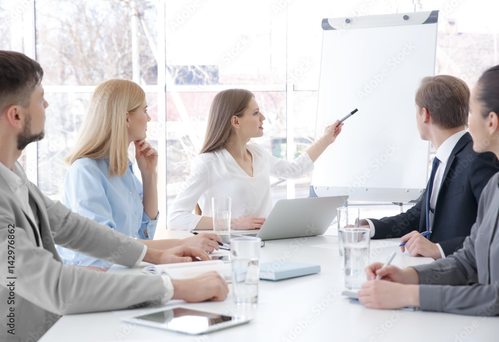 Business trainer giving presentation to group of people