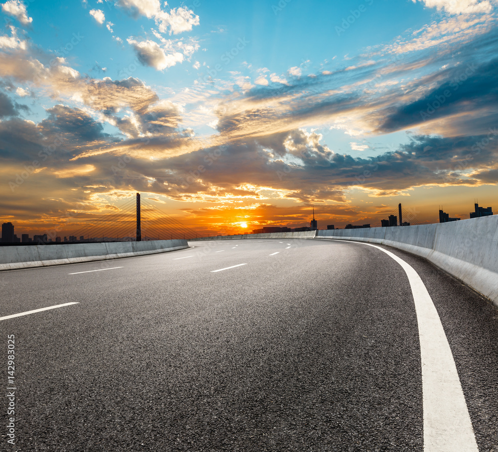 Asphalt road and beautiful sky at sunset