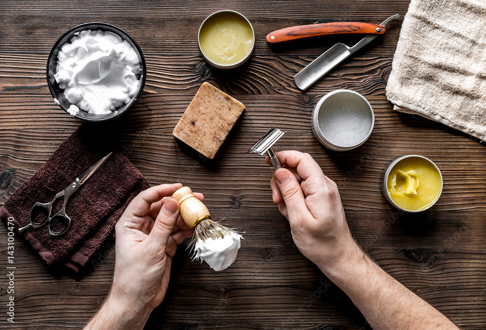 babrer workplace with tools on wooden background top view