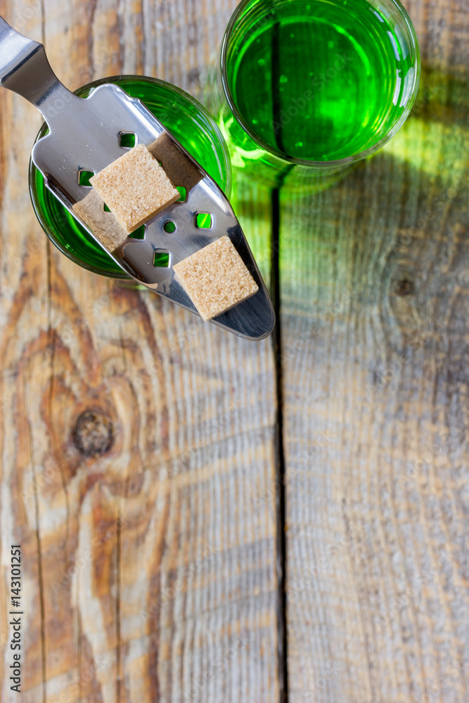 absinthe shots with sugar on wooden background top view space for text