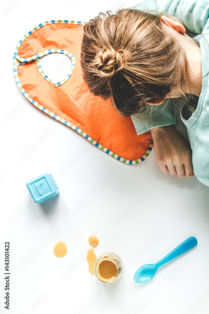 lifestyle tired mother top view on white background