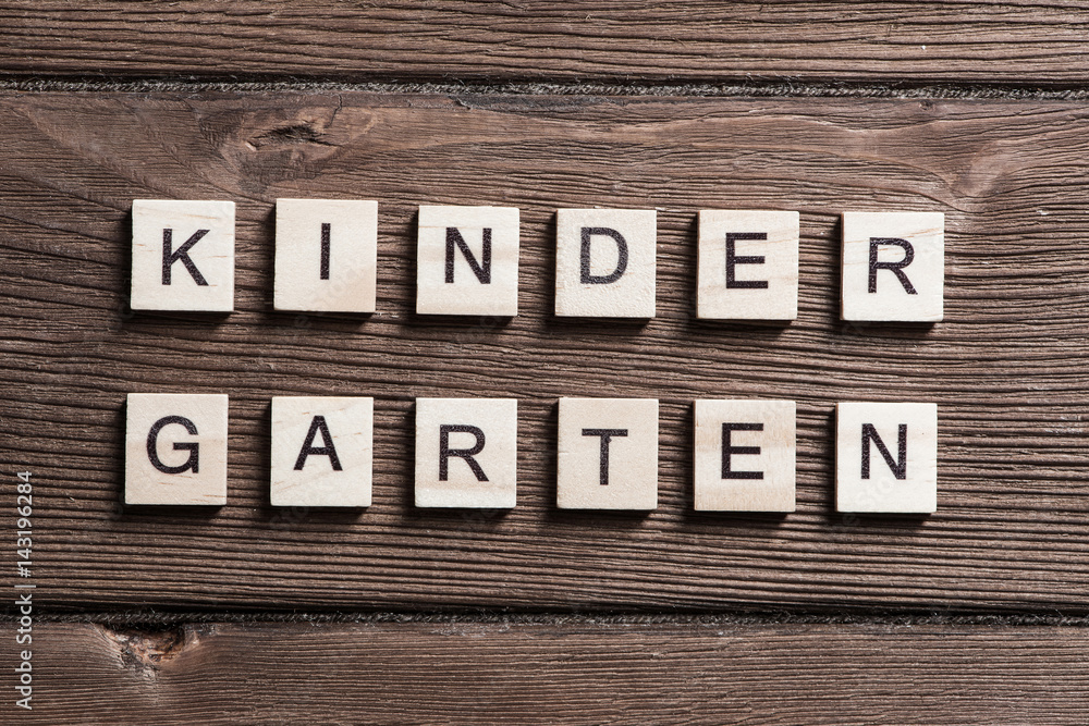 wooden elements with letter collected to word kinder garten