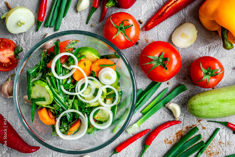 cooking vegetables on the stone background top view