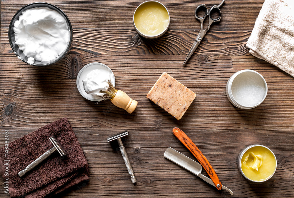 Tools for cutting beard in barbershop on workplace background top view