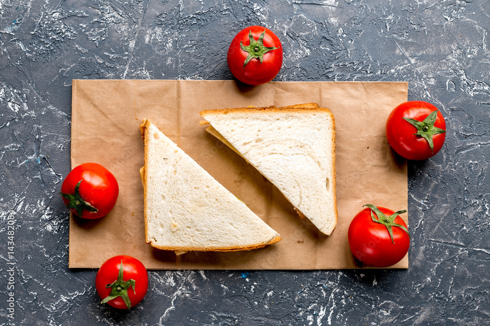 bread and vegetables on gray desk background top view