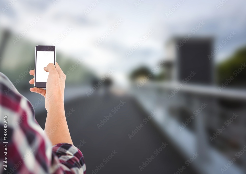 young mens hand with phone in a bridge