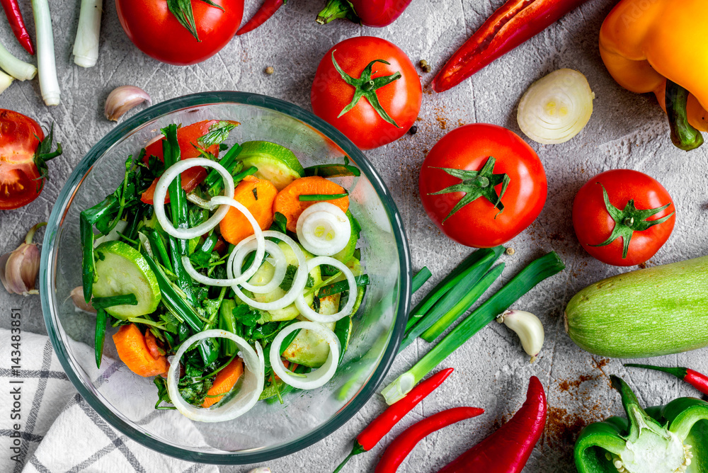 cooking vegetables on the stone background top view