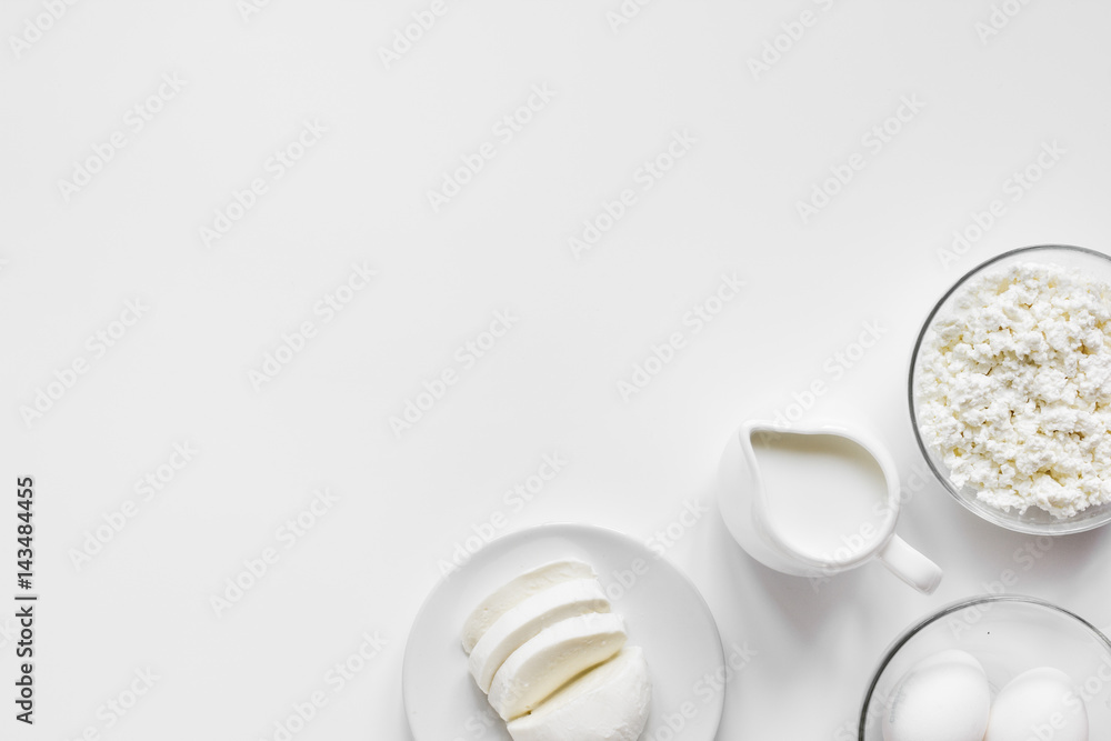 Fresh dairy products on white table background top view mockup