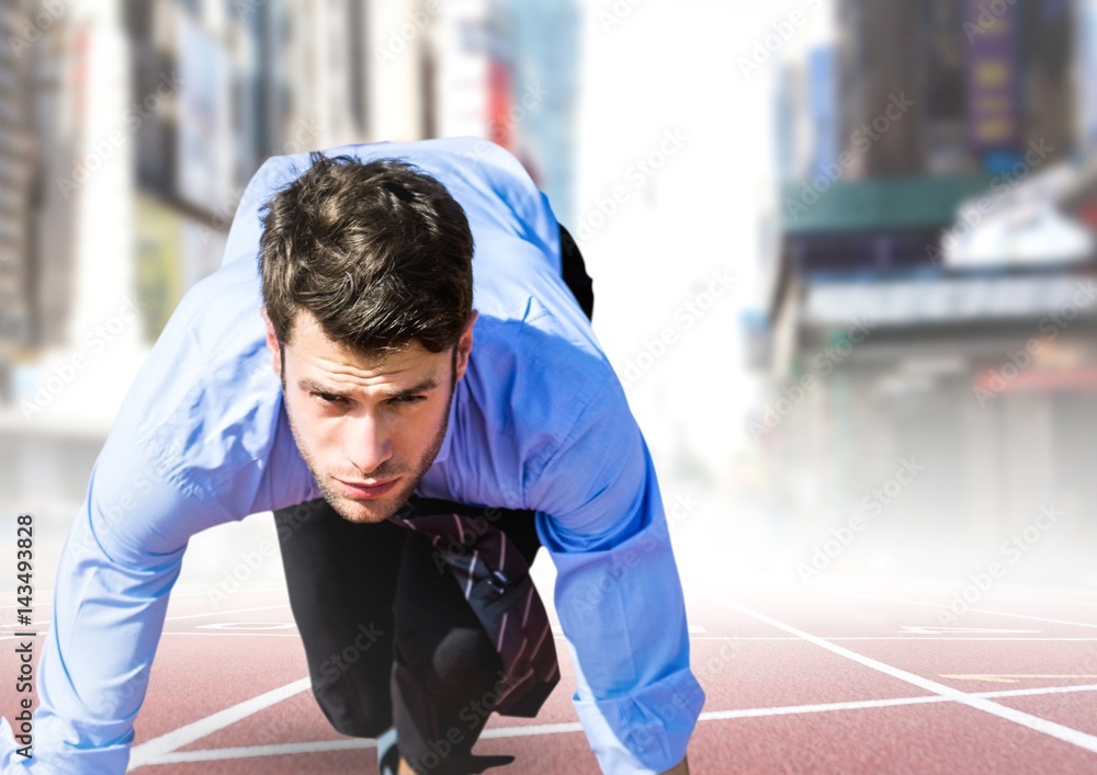 Business man in blue at start line against blurry city