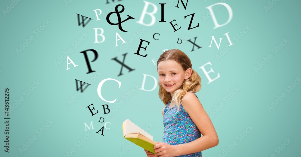 Happy girl holding book while letters flying in background