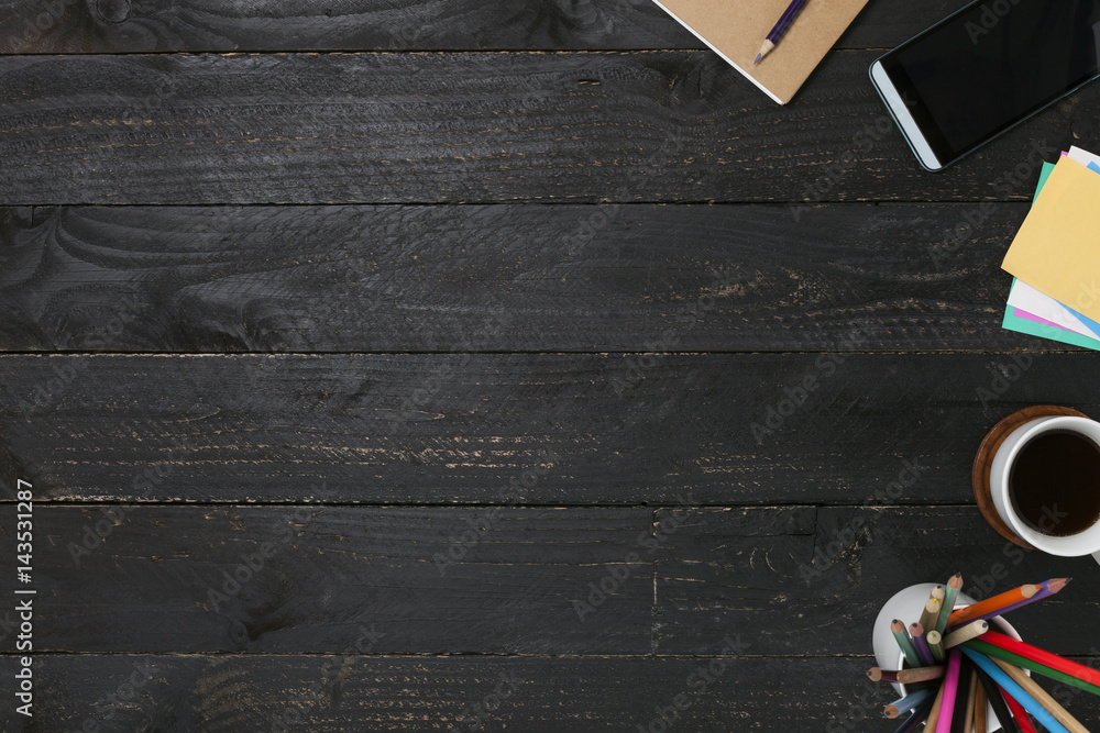 Black wooden table with Business workplace and business objects.