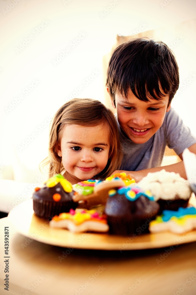 Brother and sister looking at confectionery