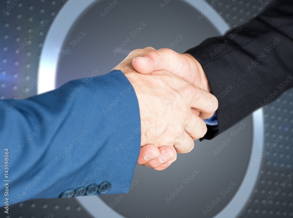 Composite image of male executives shaking hands